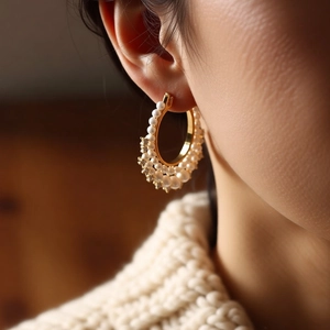 French vintage gold hoop earrings with white pearls and sparkling rhinestones on model ear