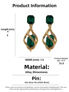 Detail view of emerald-cut crystal earrings with twisted gold cage design, 4cm x 1.5cm