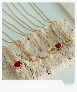 Detail of red agate and crystal heart pendants on a gold-plated titanium necklace