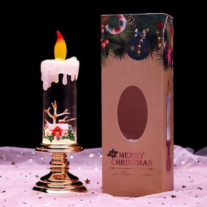 Detail of Santa lantern with snowy house inside, warm glowing LED flame and gift box