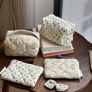 Quilted cotton makeup bag set with black hearts and purple floral prints on cream fabric
