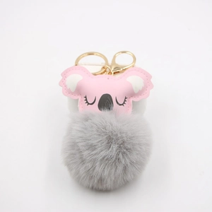 Detail of pink faux leather koala bag charm with grey faux fur pom pom and gold clasp