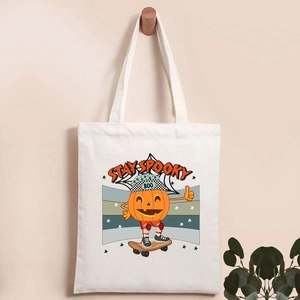 Detail of white canvas tote bag with Stay Spooky pumpkin skater print and soft texture