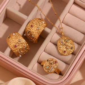 Detailed close-up of vintage gold jewelry set with celestial star and moon motifs