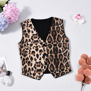 Detailed flat lay of a leopard print sequin waistcoat with elegant props and soft lighting
