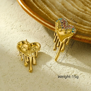 Macro detail of lava heart earrings with colorful crystals and steel studs