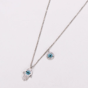 Detail of silver Hamsa Hand and Evil Eye pendant necklace with blue crystals