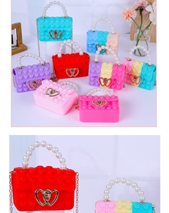 Detail of colorful heart silicone pop purses with pearl handles and gold chain straps