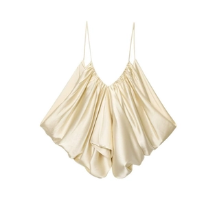 Detail of champagne satin camisole with pleated texture and glossy silk-like finish