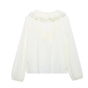 Detail of cream long sleeve chiffon blouse featuring ruffle neckline and tied V-neck
