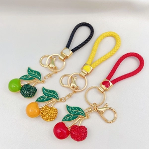 Set of three creative cherry keychains with woven leather straps and sparkling rhinestones