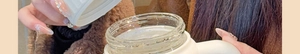 Close-up of a hand holding a high borosilicate glass tea mug with a comfortable handle