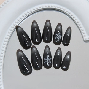Cat eye press on nails with dark starry galaxy and snowflake design in stiletto almond shape