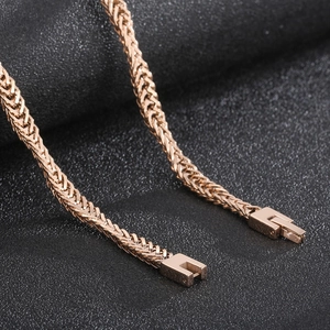 Detailed macro view of rose gold snake chain with textured irregular wave pattern links