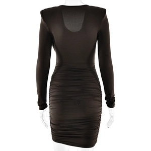 Detail view of the black long sleeve dress with ruched design on the back and hemline