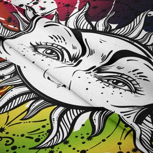 Detail shot of bohemian tapestry showing colorful celestial sun print and fabric texture