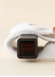 Detail showing fluorescence-free test on white mesh baby socks with zero value result