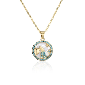 Macro detail of gold Aquarius necklace with turquoise stones and white mother of pearl inlay
