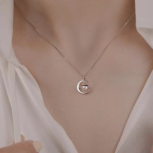 Elegant 925 sterling silver moon and pearl pendant necklace worn on a female model