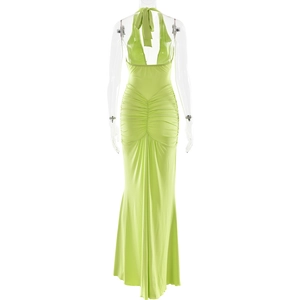 Detail view of lime green halter-neck backless dress with ruched mermaid style hem