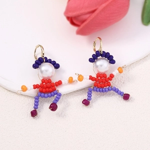 Detail of colorful beaded cartoon figure earrings with gold hooks and white pearls