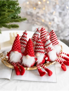 Detailed view of knitted Christmas gnomes with long legs and heart-shaped feet decorations