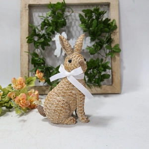 Detailed view of resin bunny with woven texture and white ribbon for garden decor