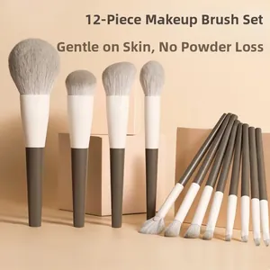 Close-up of 12 travel makeup brushes with soft grey synthetic bristles and grey handles