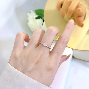 S925 sterling silver ring with pink heart diamond on a golden mirror background