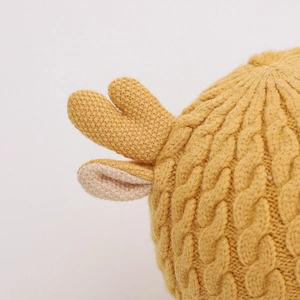 Winter baby knit hat with cute antlers and ear flaps in bright yellow cable knit