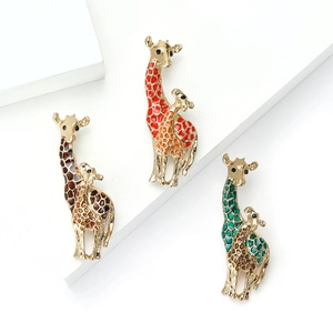 Set of three colorful enamel giraffe family brooches in brown, green, and red on gold alloy