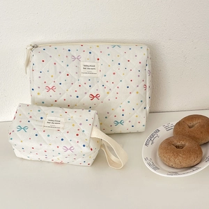Detail of quilted cotton makeup bags with colorful polka dots and bow print set