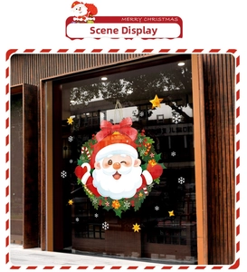 Detailed view of Christmas Santa Claus window sticker with green wreath on glass pane