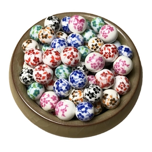 DIY ceramic flower beads set in a brown textured bowl for jewelry making and crafting