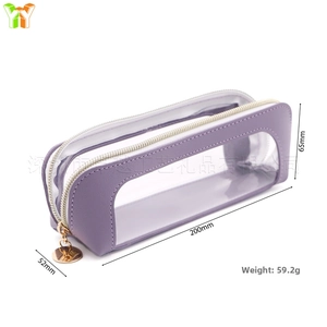 Detail of purple PU leather and transparent PVC pencil case with golden zipper