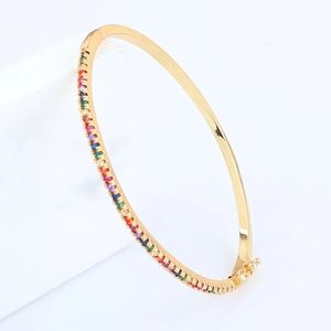 Elegant 18k gold plated rainbow zircon bangle with colorful stones on white podium
