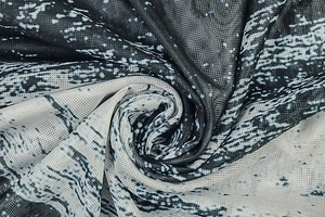 Close-up of fine mesh fabric with abstract black and white marble print texture
