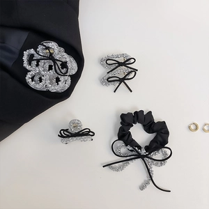 Detailed set of black ribbon and silver beaded hair clips with elegant scrunchie accessory