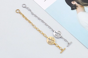 Close-up of gold and silver Tree of Life charm bracelets with a vintage toggle clasp