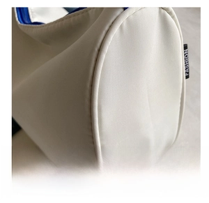 Detailed close-up of durable oxford fabric texture and fashion side label on the tote bag