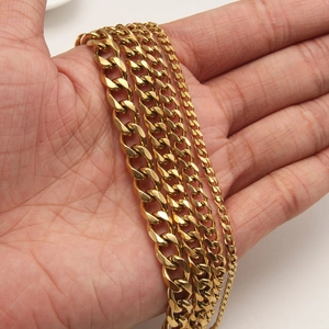 Golden Cuban link chains in four widths held in hand to show size and polished finish