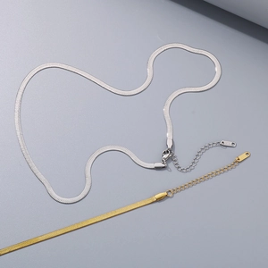 Detail of gold and silver snake bone chain necklaces with lobster clasps and extenders