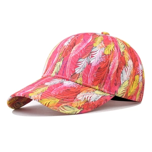 Detail of colorful feather print and stitching on a tropical style cotton baseball cap