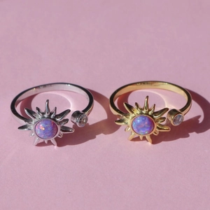 Golden and silver sunburst open rings with opal center and cubic zirconia stone
