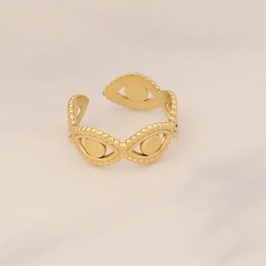 Detailed view of golden evil eye relief pattern on adjustable stainless steel band