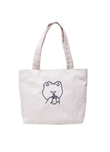Close-up of cute cartoon bear embroidery on off-white corduroy tote bag detail