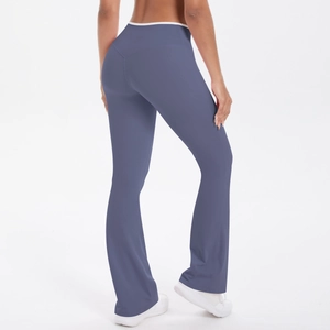 Detail of high-waisted flared yoga pants showing V-shaped lifting seams and soft blue fabric