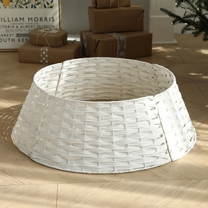 White hand-woven Christmas tree fence skirt with rustic Nordic texture for tree base decor