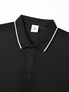 Detail view of black piqué Polo shirt neckline with collar buttons and XL inner label