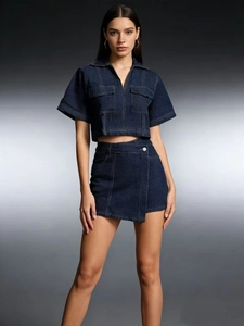 Women's dark blue denim two-piece set with a cropped zip-up top and high waist mini skirt